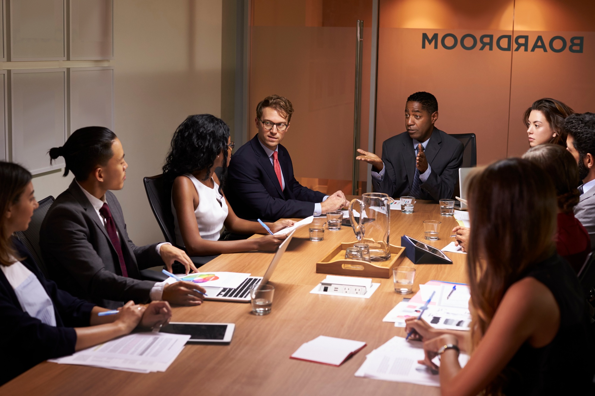 Businessman addressing corporate colleagues at a meeting